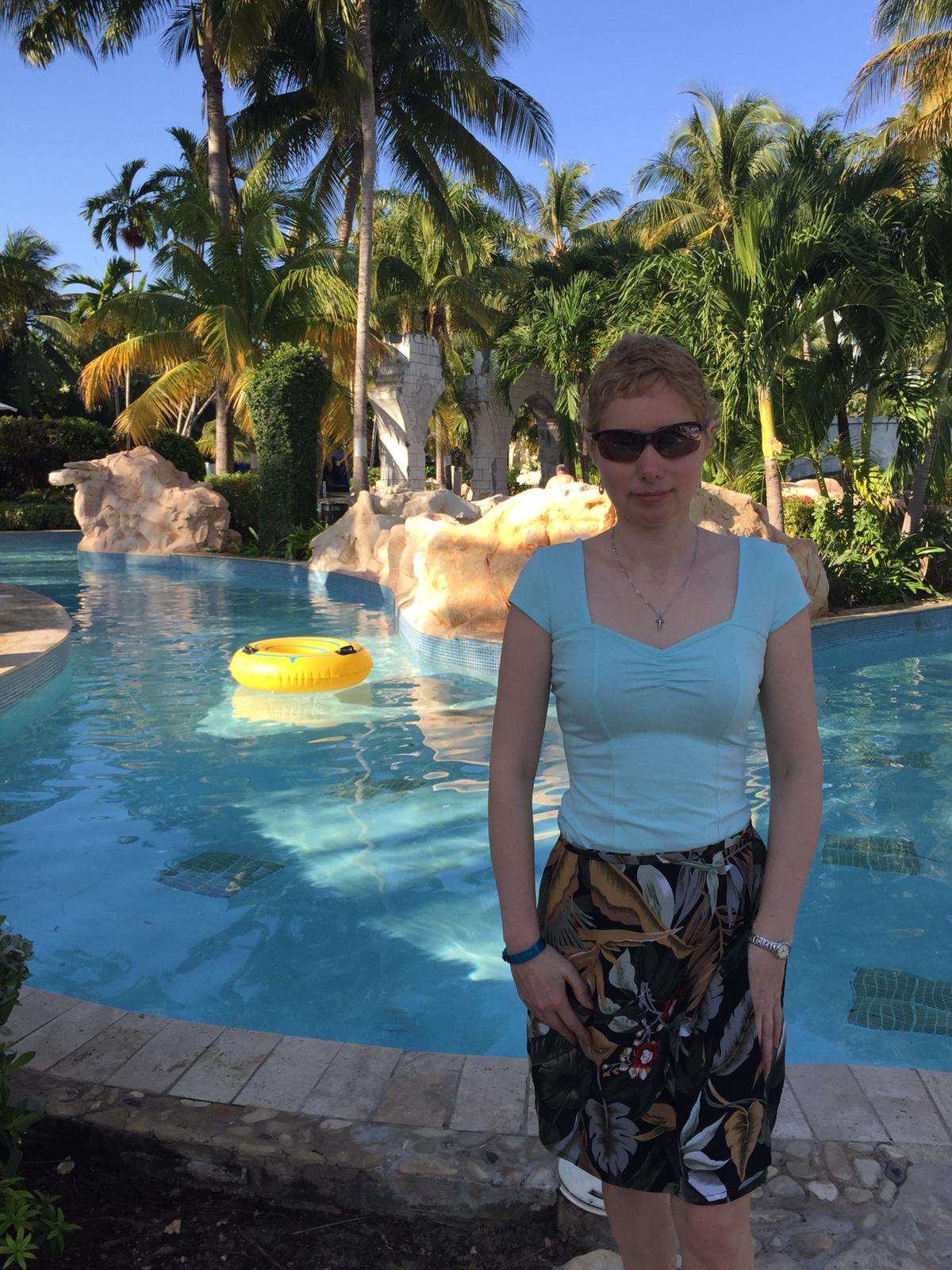Elena in hawaiian print skirt poolside