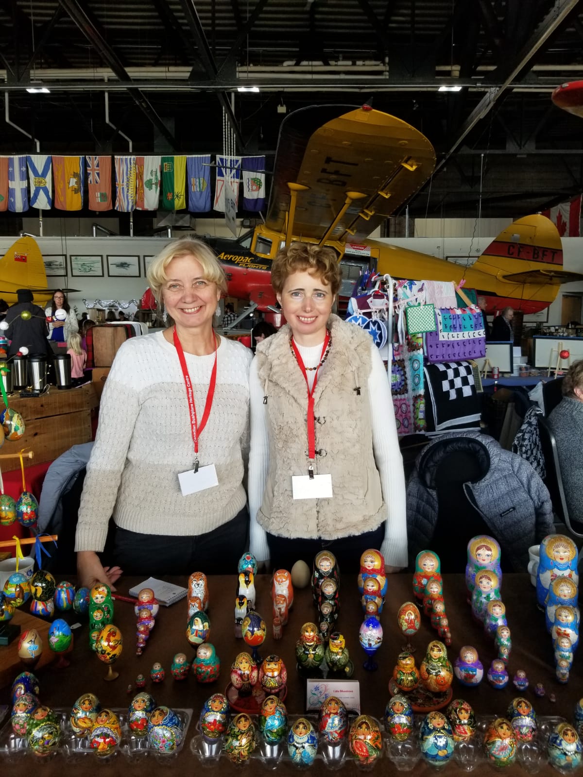  Elena and Lidia at a trade show displaying painted eggs and russian dolls. 