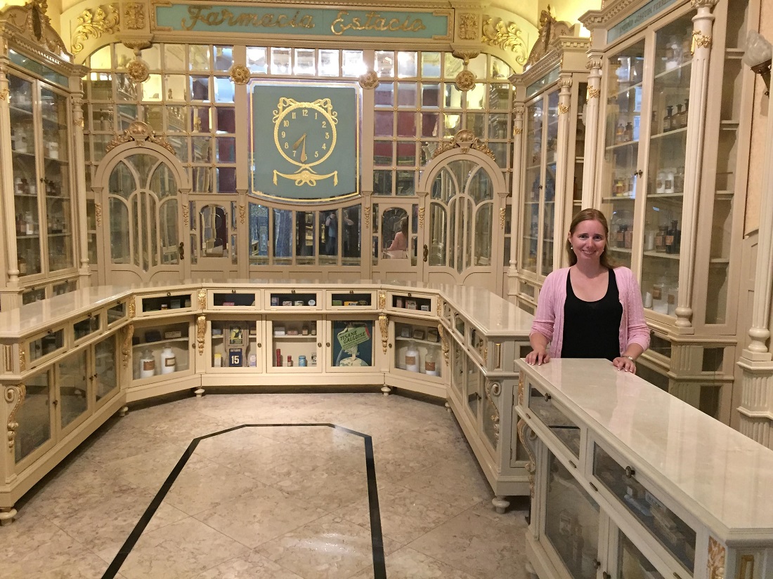  Elena posed inside an marble room with marble and glass cabinets 