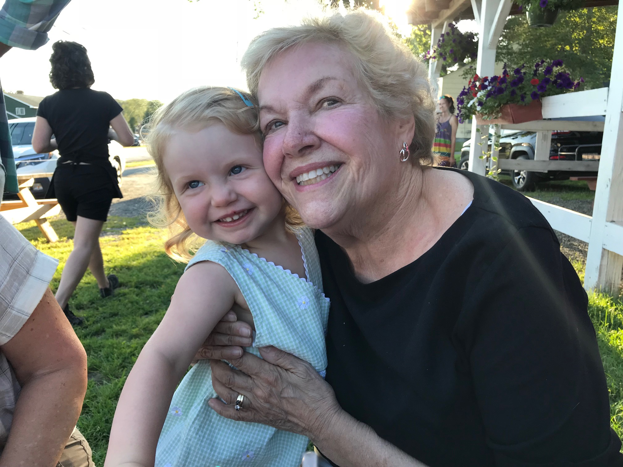 Liza hugging grandchild outdoors